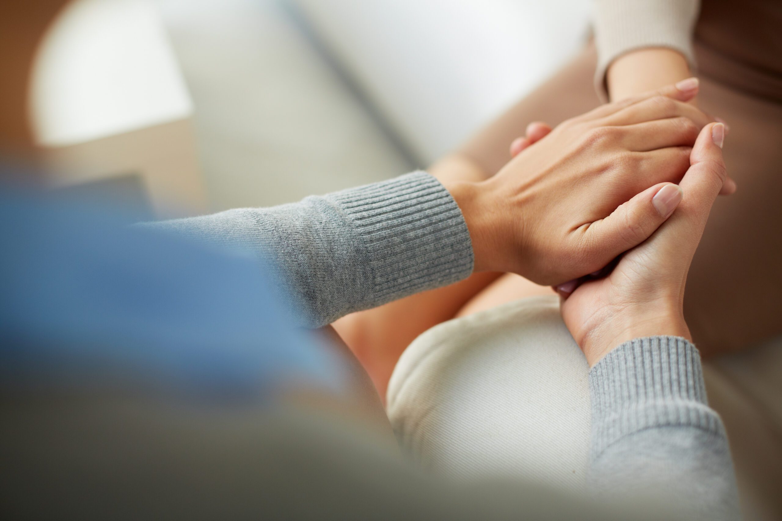 Psychiatrist hands together holding palm of her patient